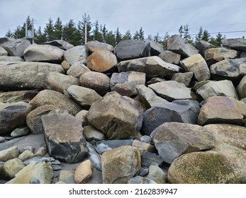 A Large Rock Wall Piled Up Not So Neatly.