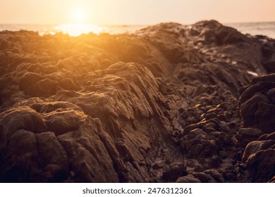 A large rocks surrounded by waves of the ocean