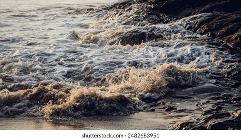 A large rocks surrounded by waves of the ocean