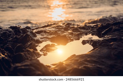 A large rocks surrounded by waves of the ocean