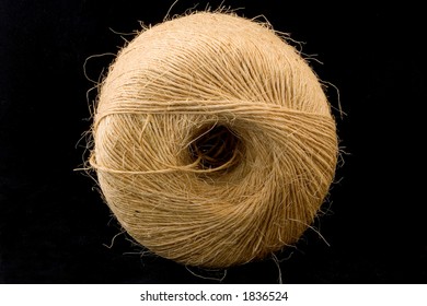 A Large Roll Of Twine On A Black Background.