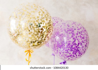 Large Round Balloons. Big Balls With Confetti. Balls Of Gold And Purple Color