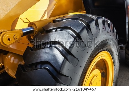 large rubber wheels of a tractor, grader, bulldozer or construction equipment.