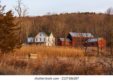 Large Rural Country Home And Red Barn In Dry Winter Landscape