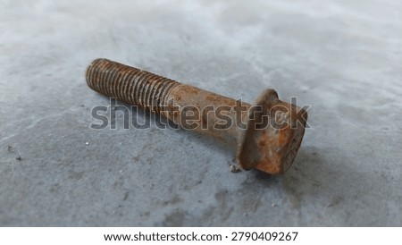 Large rusty bolt on a gray background