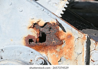 Large rusty hole in the base of an old gun