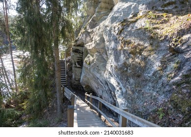 Large Sandstone Cliffs Of Sietiniezis On The Shore Of The River Gauja In Latvia. Tourist Nature Trail For Hiking With Wooden Stairs.