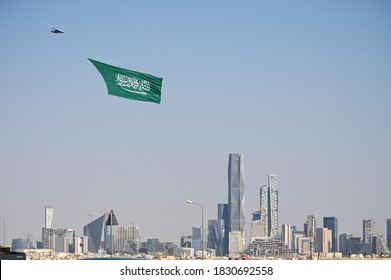 Large Saudi Arabia flag flies over Riyadh city with helicopter calibrating the National Day. - Shutterstock ID 1830692558