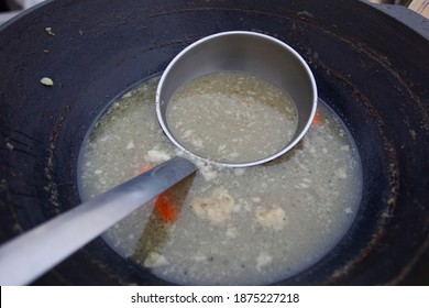 Large Scoop In A Vat Or Pot Of Soup. Street Food.