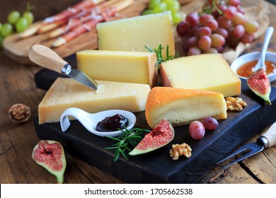 Large Selection Of Cheeses On Wooden Board