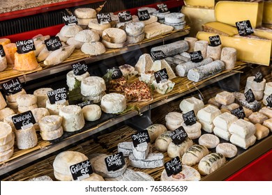 A Large Selection Of Different French And Italian Cheeses On The Counter Of A Small Store At The Aligre Market (Marche D'Aligre) In The Bastille District. Paris, France