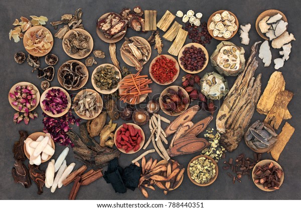 Large\
selection of traditional chinese herbs used in alternative herbal\
medicine in wooden bowls and loose. Top\
view.\
