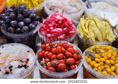 A large selection of various canned vegetables at the farmer's market