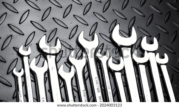 Large\
Set of metal silver wrenches on metal\
background