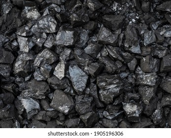 Large shiny chunks of black heating coal, top view.