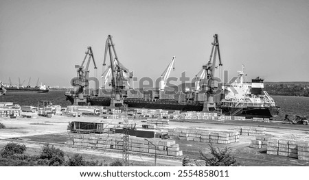 large ship loading grain for export. Water transport. Black and white