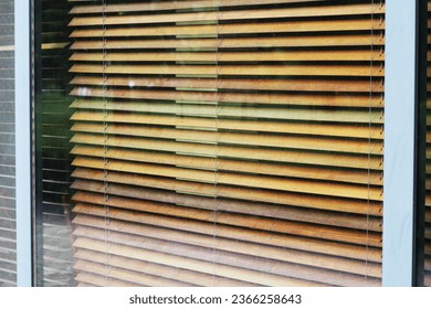 Large shop window with blinds and urban background reflection mockup template. Empty office window for business logo mock up template.