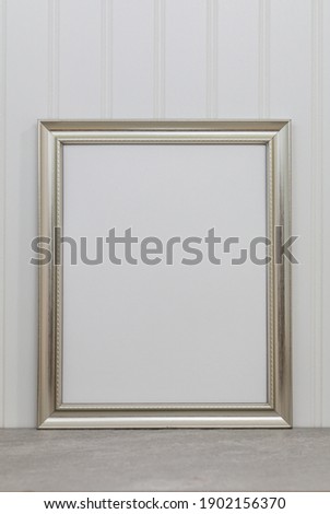 Large silver frame mockup against white wainscot wall for art or copy space