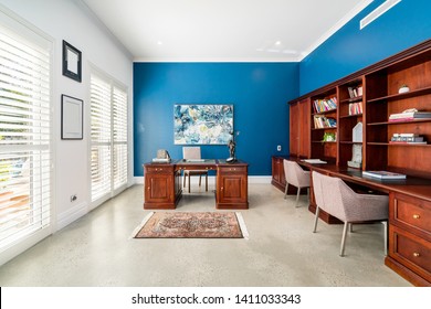 Large Sized Home Office With Full Length Timber Cabinetry And Colourful Walls. PERTH, AUSTRALIA. MAY 2019.
