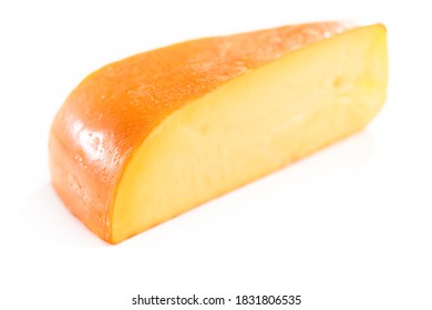 Large Slice Of Smoked Gouda Cheese On A White Background.