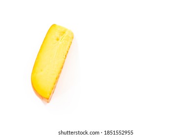 Large Slice Of Smoked Gouda Cheese On A White Background.