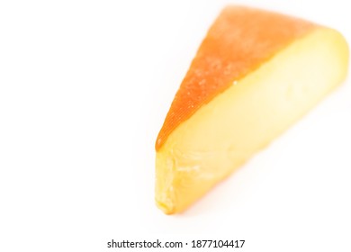 Large Slice Of Smoked Gouda Cheese On A White Background.