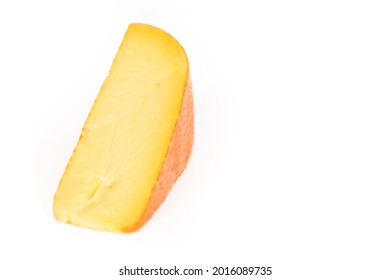 Large Slice Of Smoked Gouda Cheese On A White Background.