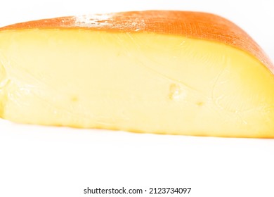 Large Slice Of Smoked Gouda Cheese On A White Background.