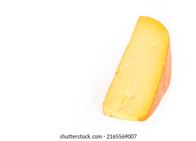 Large Slice Of Smoked Gouda Cheese On A White Background.