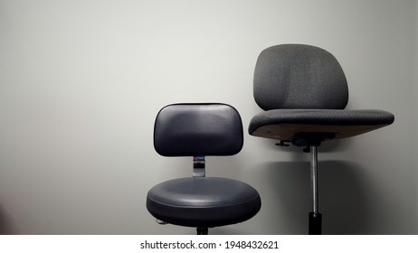 Large And Small Grey Stools Against A Grey Wall