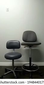 Large And Small Grey Stools Against A Grey Wall