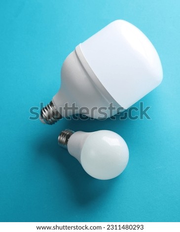 Large and small led light bulbs on a blue background