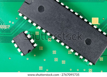 large and small microcircuits on a green printed circuit board