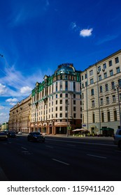 Large solid building on the background of the city empty traffic road with the urban landscape.