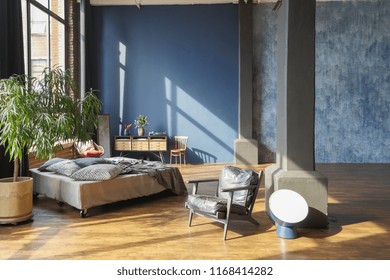 Large Spacious Loft Room In Dark Colors In The Rays Of Sunlight With Big Window. Free Lay-out