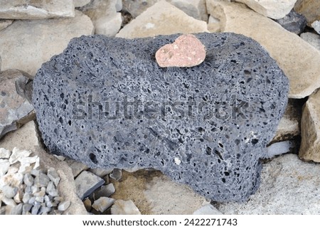 Large specimen of black volcanic breccia rock. Close up macro of volcano stone.