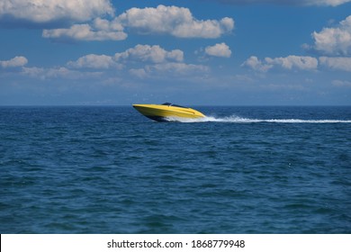 Large Speedboat Moving At High Speed. Yellow Boat Fast Movement. Large Speed Boat Moving At High Speed Side View.