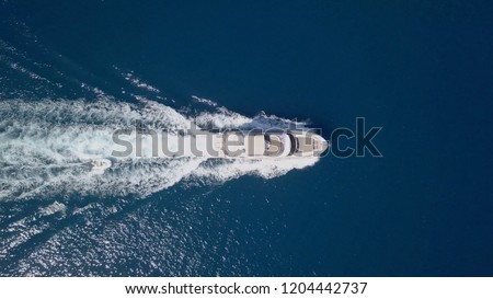 Large speedboat roaring across the Mediterranean Sea - Top down aerial image.