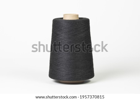 Large spool of thread, black, close-up. Isolated on white background