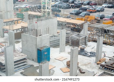 Large Square Footage Of A Commercial Building With Concrete Forms, Rebar, And Electrical Wires. The Foundation Of The Skyrise Building Was Built. The Construction Site Has The Base Of A Crane.