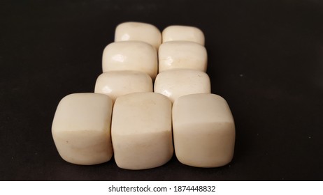 Large, square, white African jewelry making Bone beads, stacked side by side in pyramid type rows. - Powered by Shutterstock