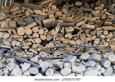 A large stack of chopped firewood is piled high, ready for use.