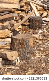 large stack of firewood with axe