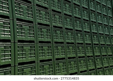 large stack of green industrial plastic crates commonly used for storage and transportation of agricultural produce