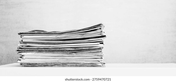 a large stack of newspapers on the table is a black and white photo with copy space
