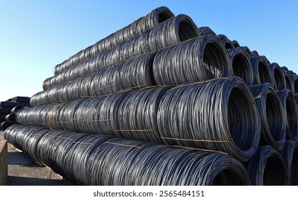 Large stack of steel wire rods in the outdoor steel mill storage.