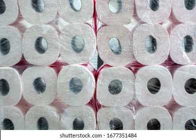 A large stack of toilet paper. A stockpile toilet paper with pink print in packaging. Concept of hoarding products due to coronavirus pandemic