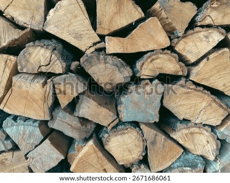 A large stack of wooden logs.