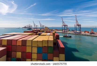 Large Stacked Container Ship In The Ben Schoeman Dock, Leaving The Port Of Cape Town With Tug Assistance, South Africa.