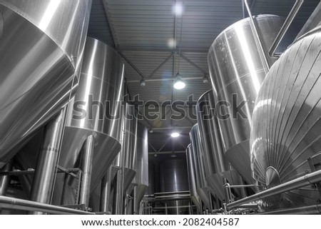 Large stainless steel tanks for brewing beer. Brewing production.